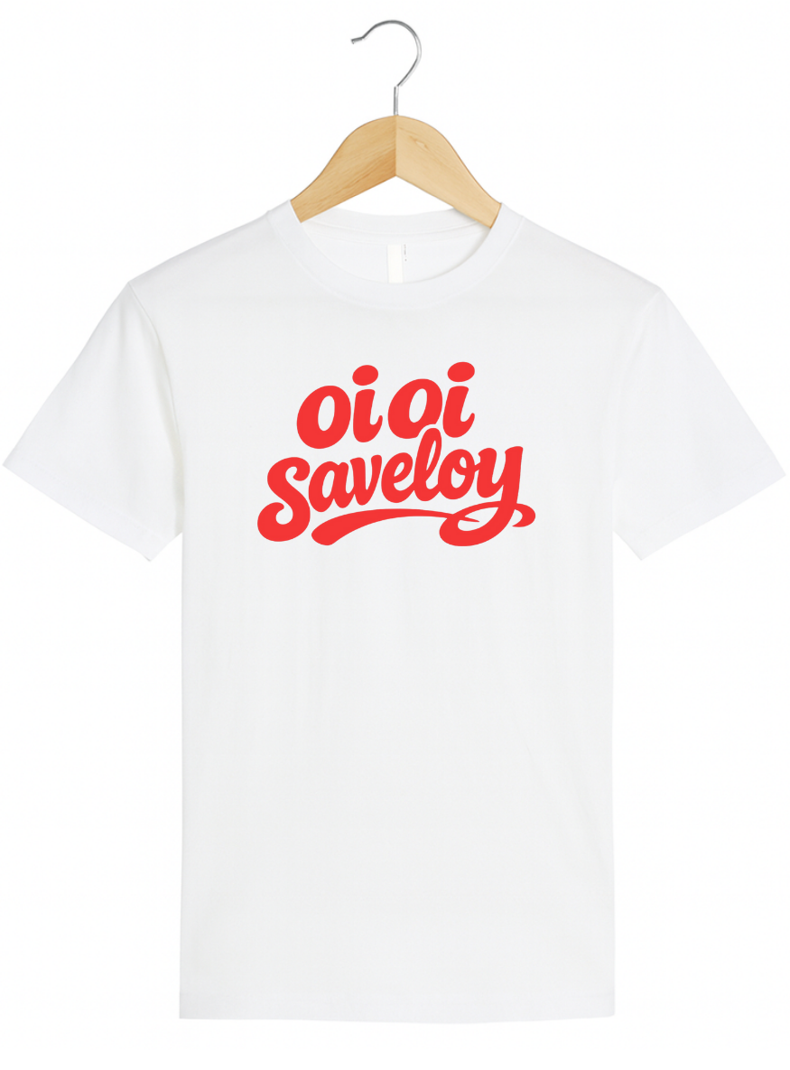 White t-shirt on a wooden hanger featuring bold red script text reading “Oi Oi Saveloy” on the front.