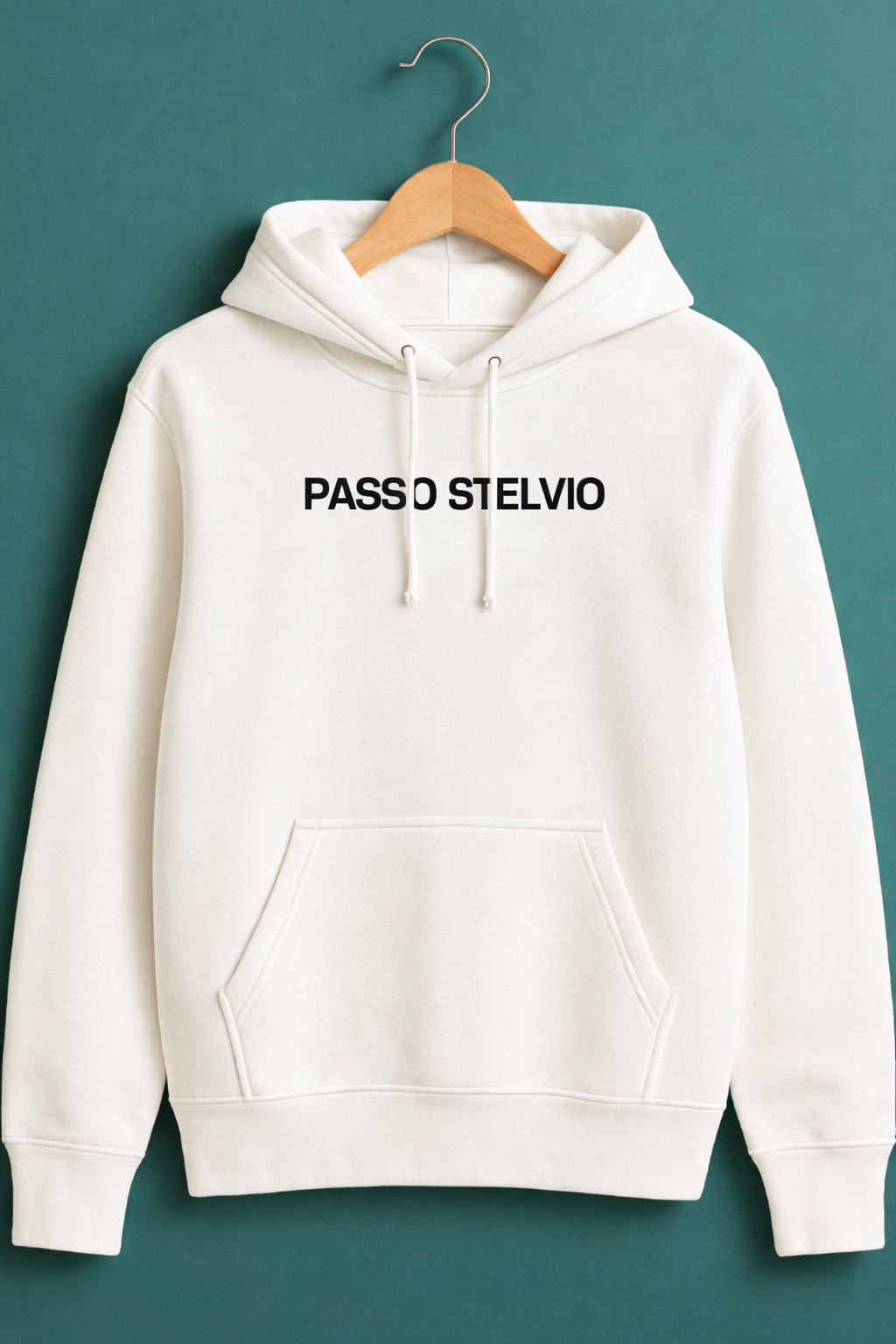 White hoodie displayed on a wooden hanger against a teal background, featuring a bold Passo Stelvio mountain crest graphic on the back with elevation, hairpins, and average gradient details.