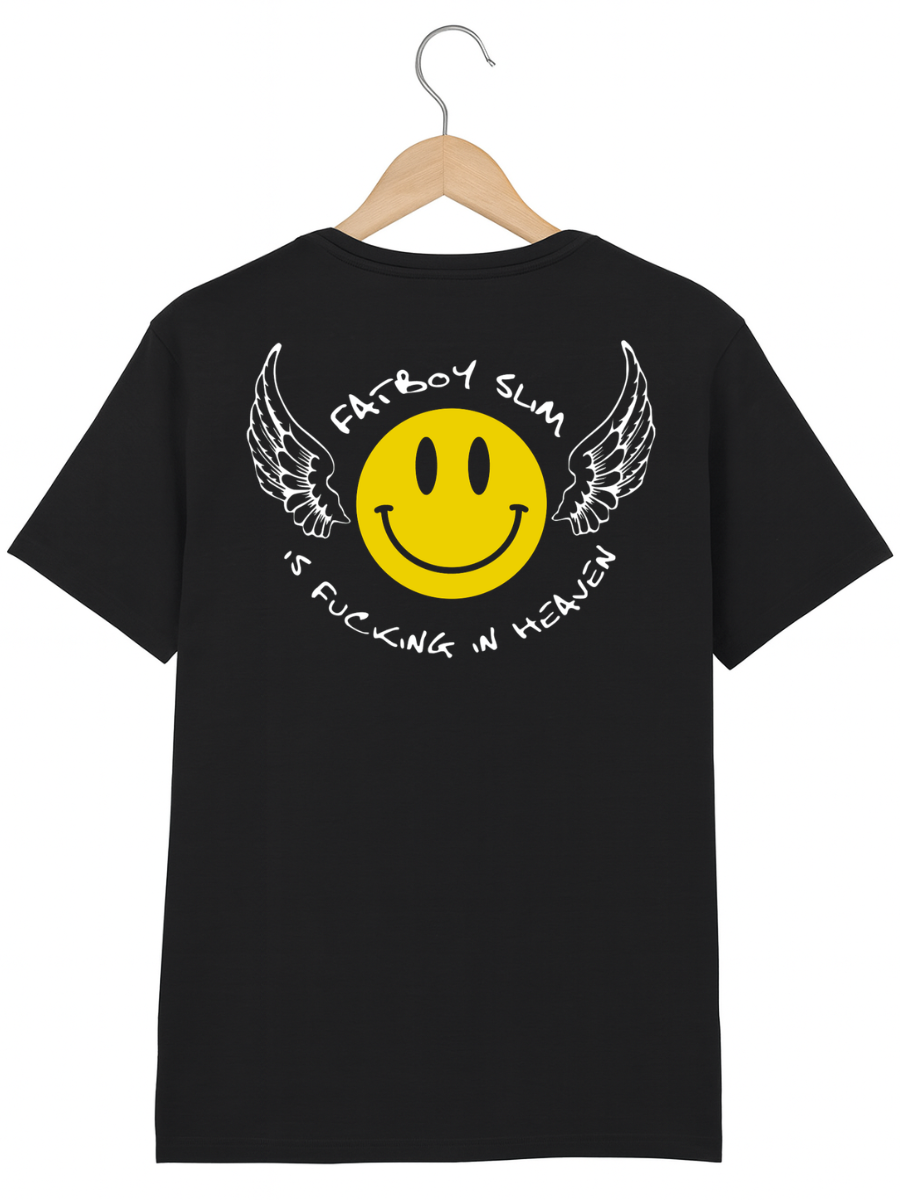 A black short-sleeve t-shirt hanging on a wooden hanger against a white background, featuring a large back graphic with a yellow smiley face, white wings, and white text reading 'Fatboy Slim' and 'Is Fucking in Heaven'.