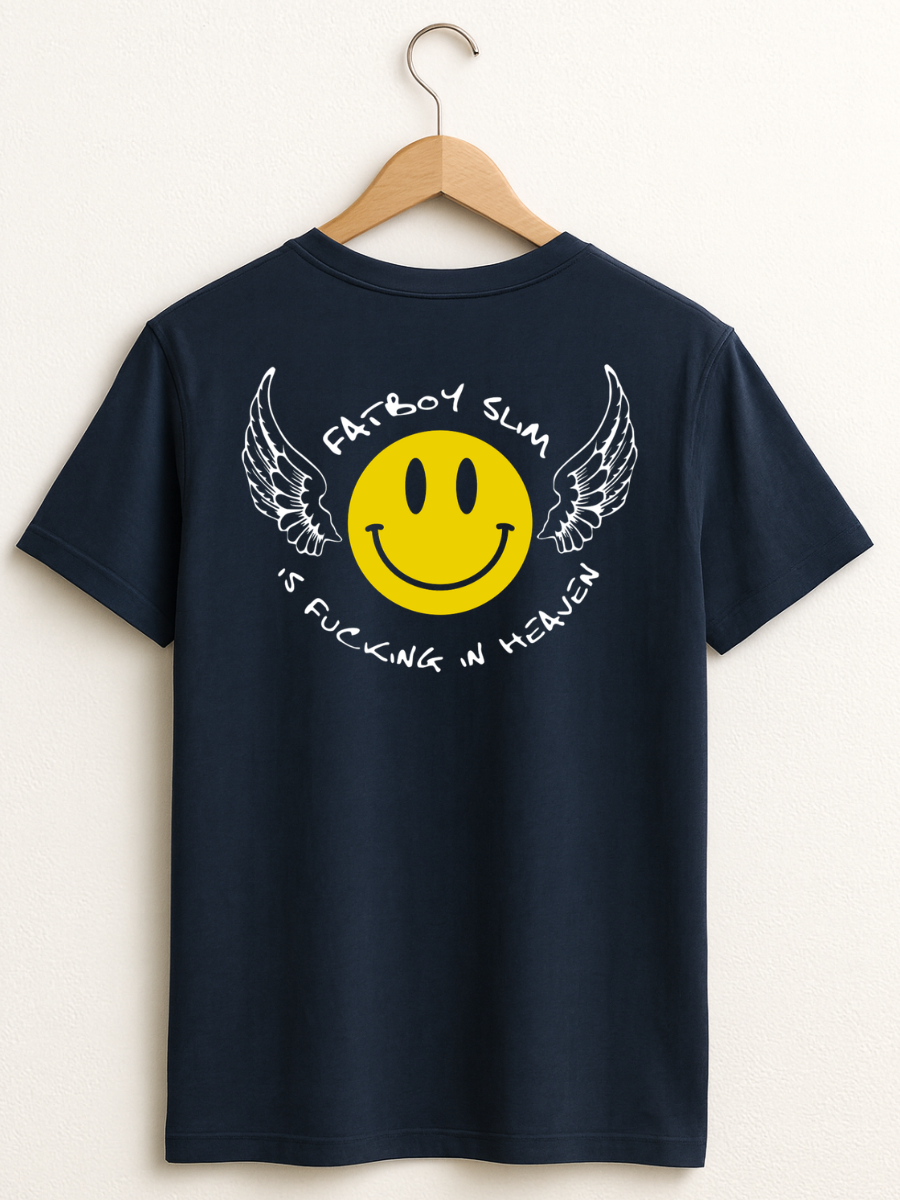 A navy blue t-shirt hanging on a wooden hanger against a light beige wall. The back of the shirt features a graphic print of a yellow smiley face with white wings and white text reading 'PATBOY SLAM' and 'IS FUCKING IN HEAVEN'.