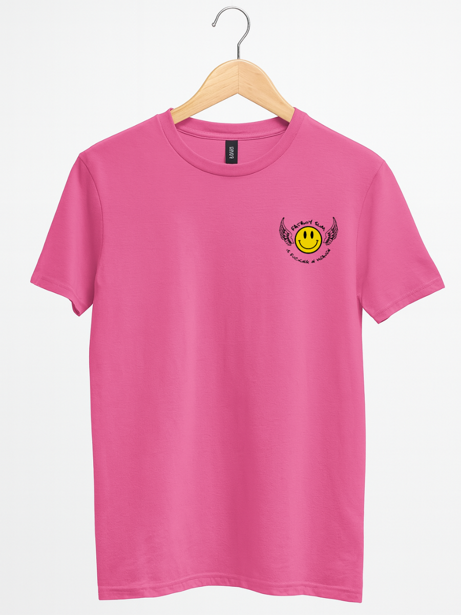 A bright pink short-sleeve t-shirt hanging on a wooden hanger against a light gray background. The shirt features a small graphic on the left chest with a yellow smiley face inside a black circle, surrounded by black wings and the text 'SADLY UNAPOLOGETIC'.