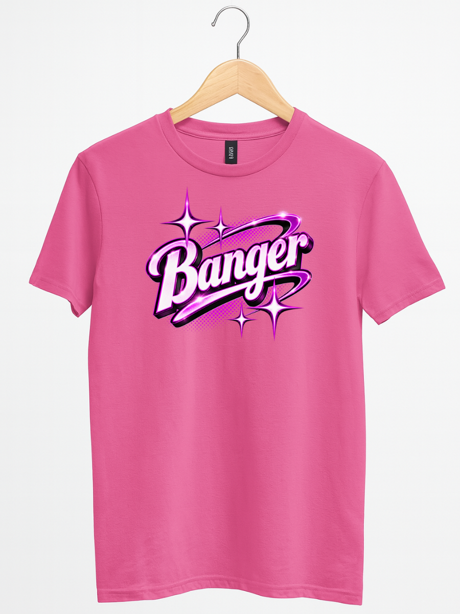 A pink short-sleeve t-shirt hanging on a wooden hanger against a light gray background. The shirt features a large graphic on the chest with the word 'Banger' in stylized white and purple lettering surrounded by pink and purple sparkles.