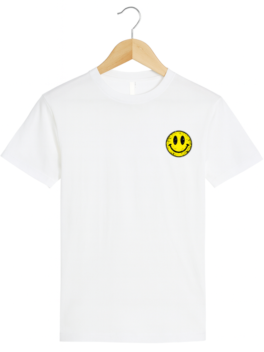 A white short-sleeve crewneck t-shirt hanging on a light wood hanger with a metal hook, featuring a small yellow smiley face graphic on the left chest.