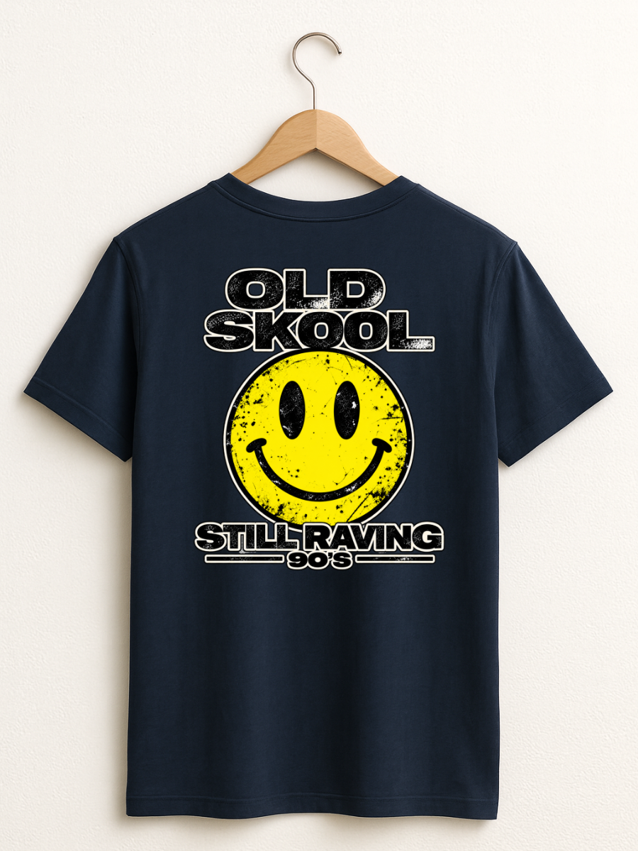 A navy blue t-shirt hanging on a wooden hanger against a light beige wall. The shirt features a large graphic print on the front with the text 'OLD SKool' and 'STILL RAVING 80's' surrounding a yellow retro smiley face.