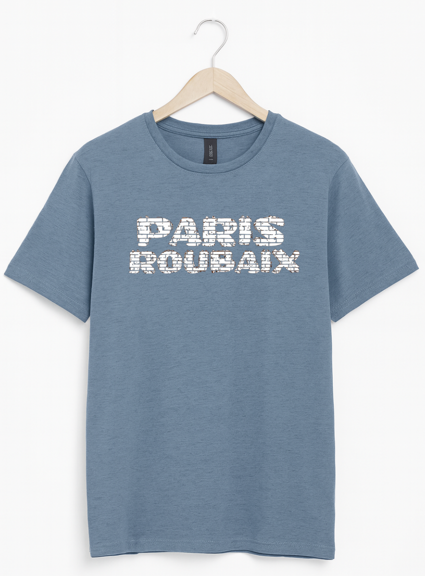 Blue t-shirt with 'PARIS ROUBAIX' text on a hanger against a white background