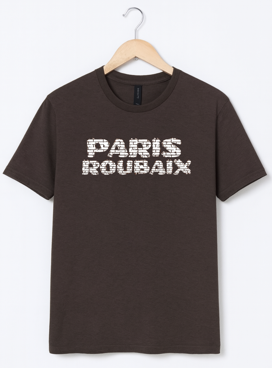 Brown t-shirt with 'PARIS ROUBAIX' text on a hanger against a white background