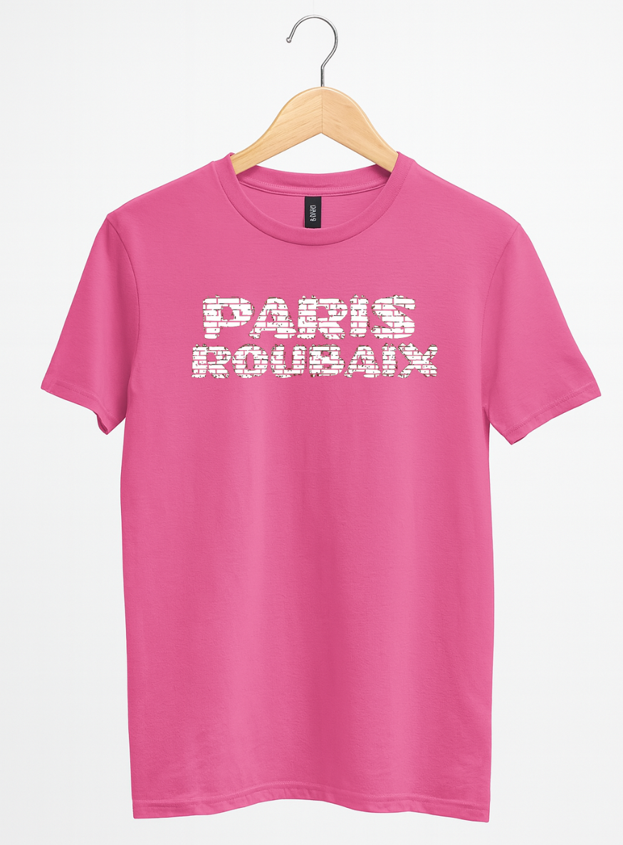 Pink t-shirt with 'PARIS ROUBAIX' text on a hanger against a white background