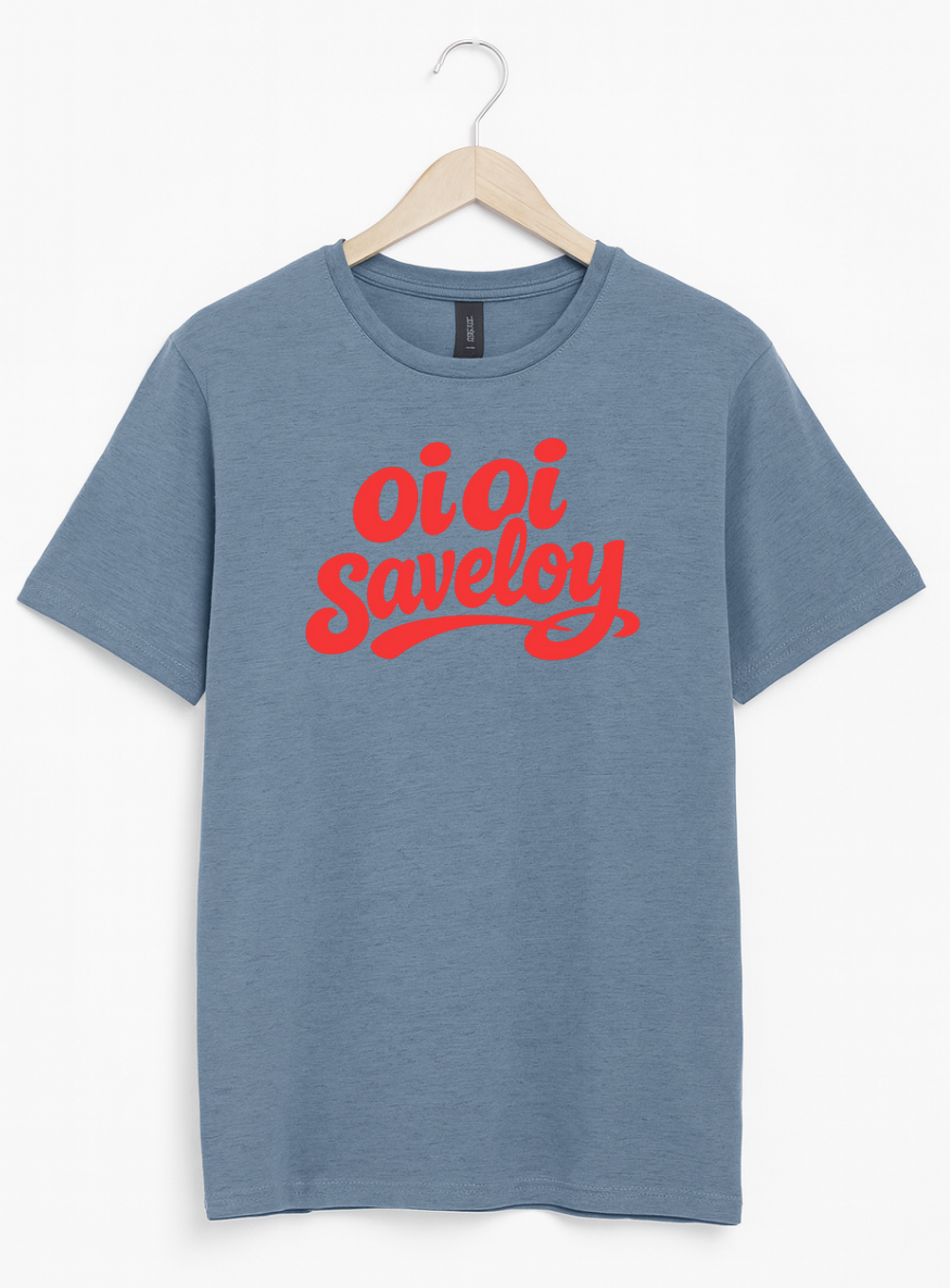 Blue t-shirt on a wooden hanger featuring bold red script text reading “Oi Oi Saveloy” on the front.