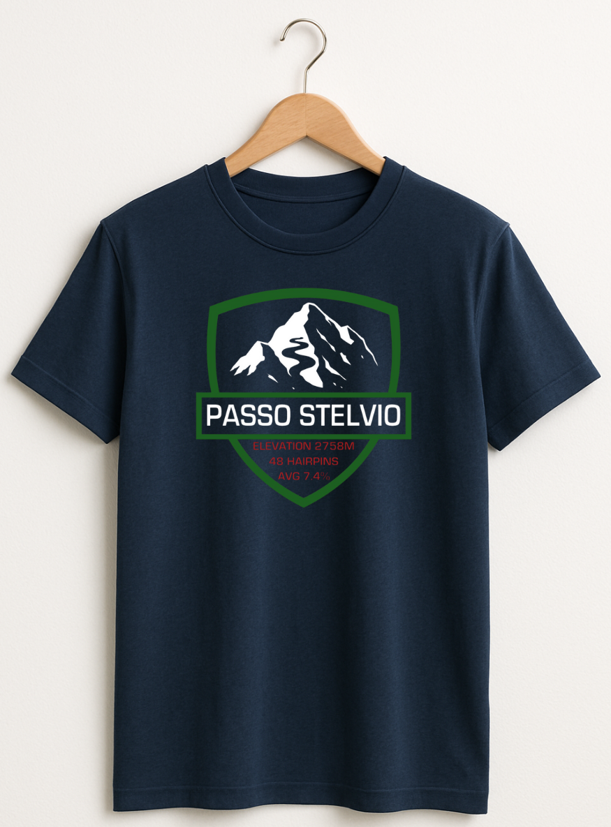 Navy blue t-shirt with mountain graphic and 'Passo Stelvio' text on a hanger against a white background