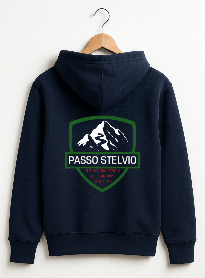 Navy hoodie displayed on a wooden hanger against a teal background, featuring a bold Passo Stelvio mountain crest graphic on the back with elevation, hairpins, and average gradient details.