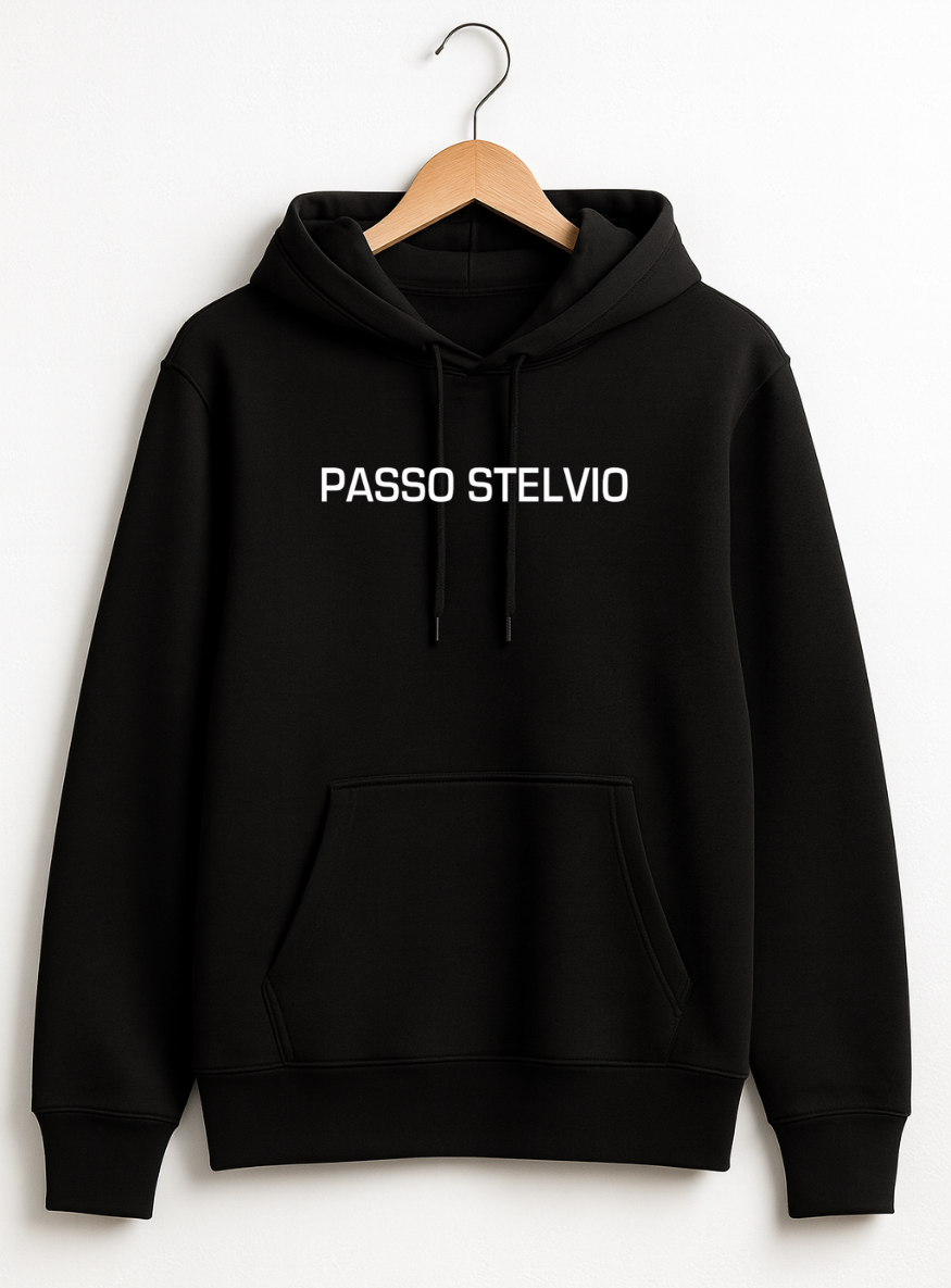 Black hoodie displayed on a wooden hanger against a teal background, featuring a bold Passo Stelvio mountain crest graphic on the back with elevation, hairpins, and average gradient details.