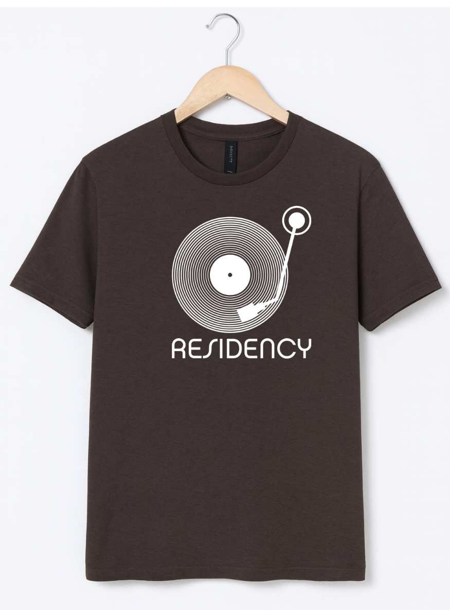 Brown t-shirt with a record player graphic and 'Residency' text on a hanger against a white background