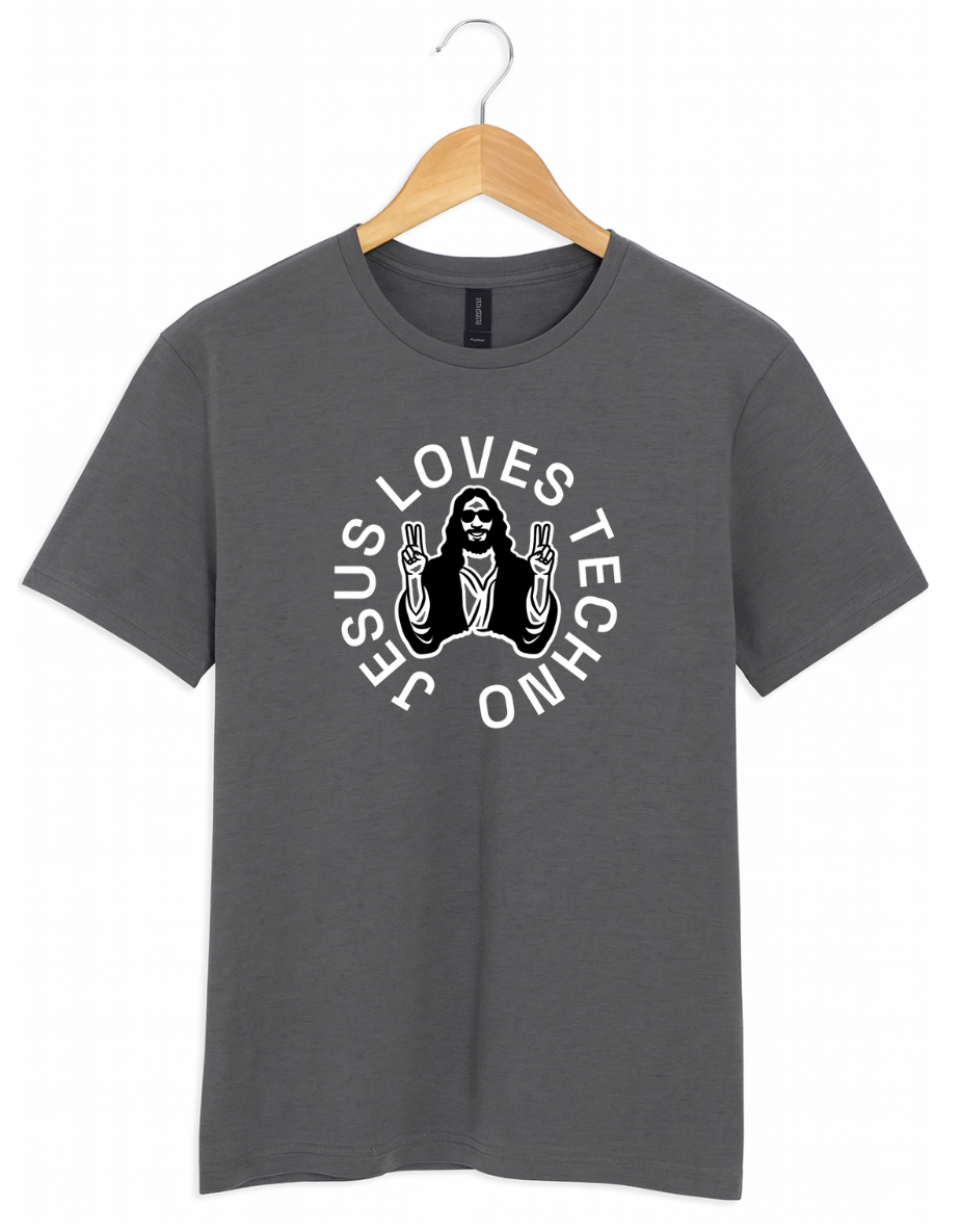 Grey t-shirt on a wooden hanger featuring a white “Jesus Loves Techno” graphic with a stylized illustration of Jesus wearing sunglasses and making peace signs.
