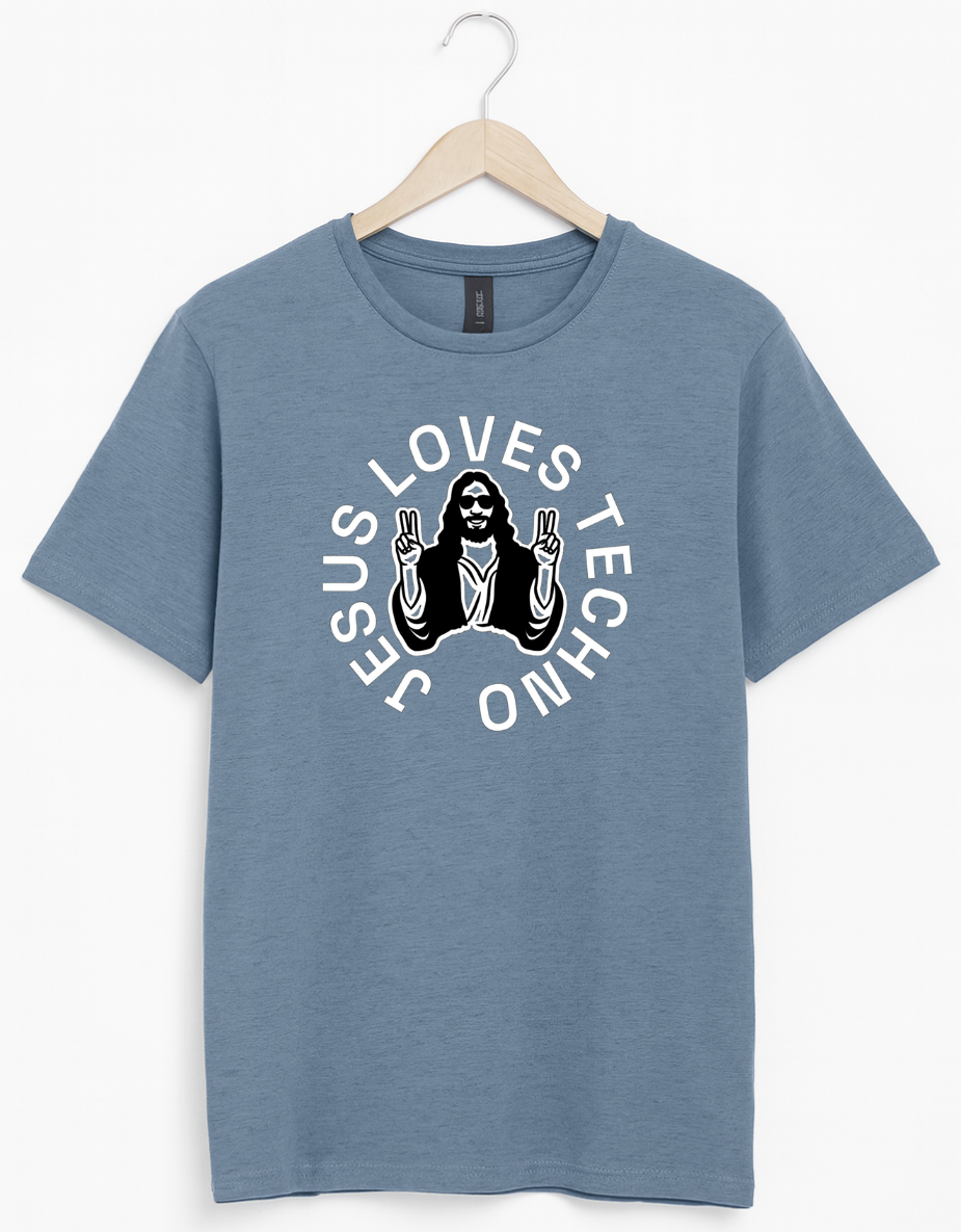 Blue t-shirt on a wooden hanger featuring a white “Jesus Loves Techno” graphic with a stylized illustration of Jesus wearing sunglasses and making peace signs.