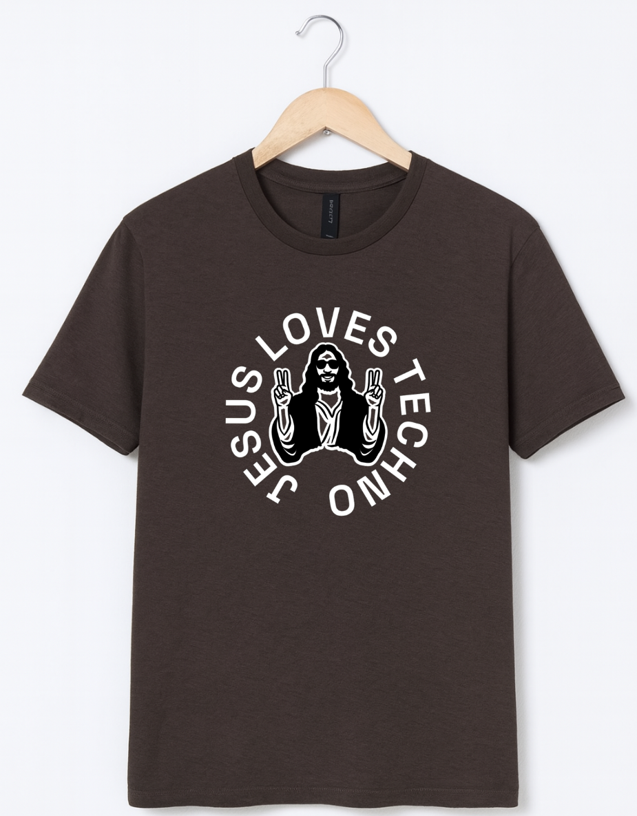 Brown t-shirt on a wooden hanger featuring a white “Jesus Loves Techno” graphic with a stylized illustration of Jesus wearing sunglasses and making peace signs.