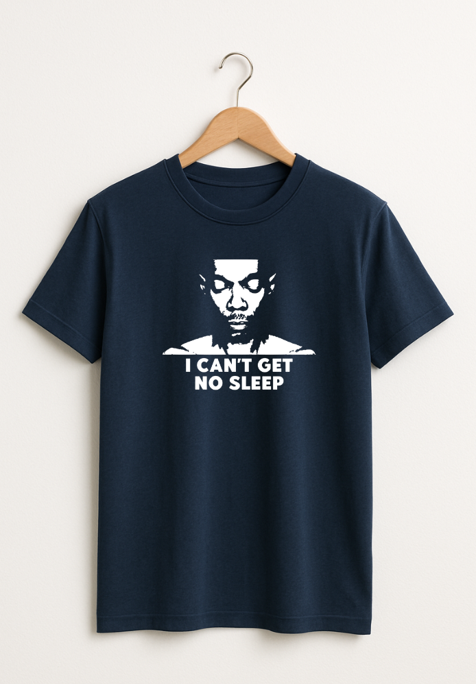Navy blue T-shirt hanging on a wooden hanger with a white graphic of a face and the text “I Can’t Get No Sleep” on the front.