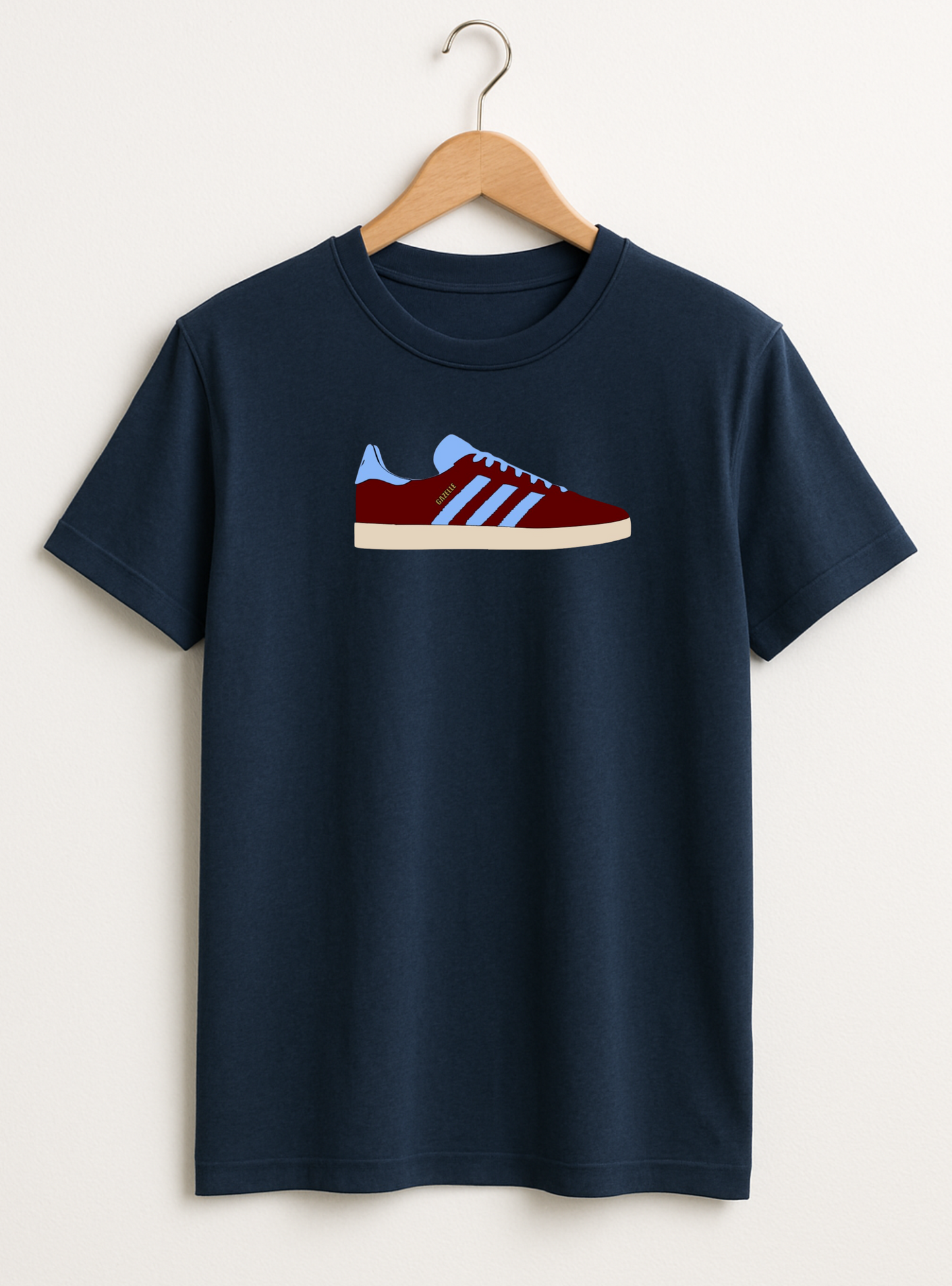 Navy blue t-shirt with a red and white sneaker graphic on a hanger against a white background
