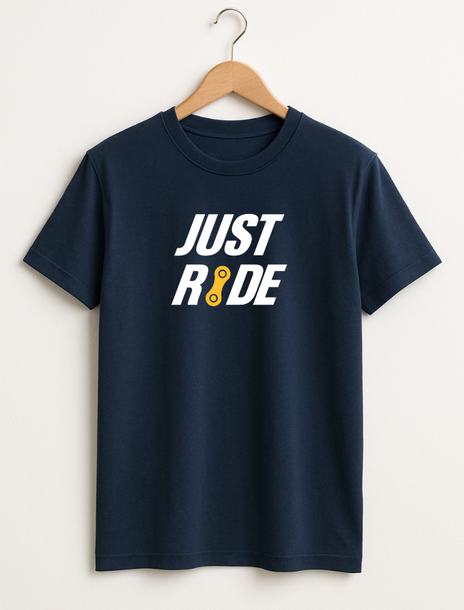 Navy blue t-shirt with 'JUST RIDE' text on a hanger against a white background