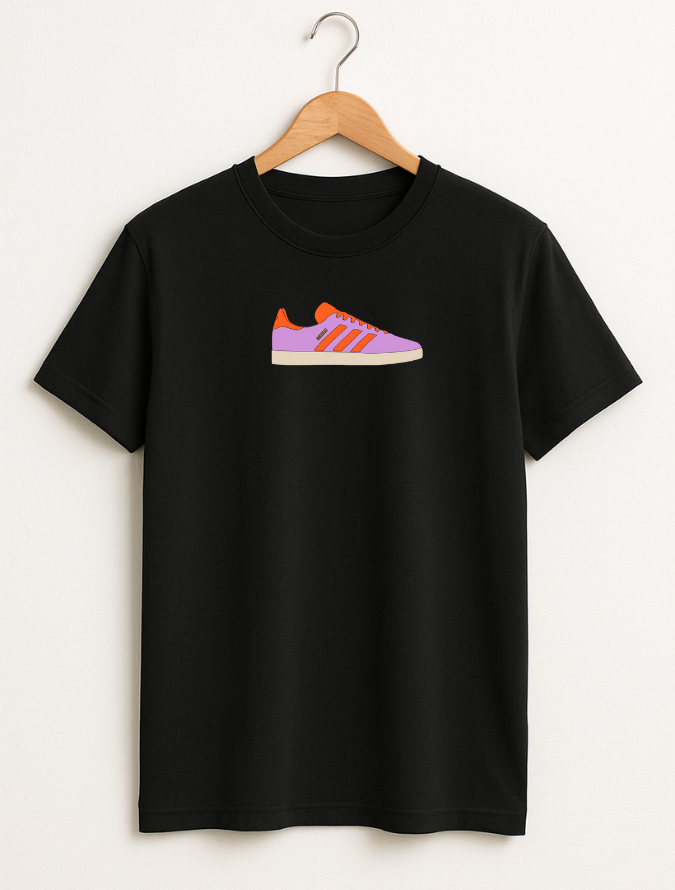 Black t-shirt with a colorful shoe graphic on a hanger against a white background