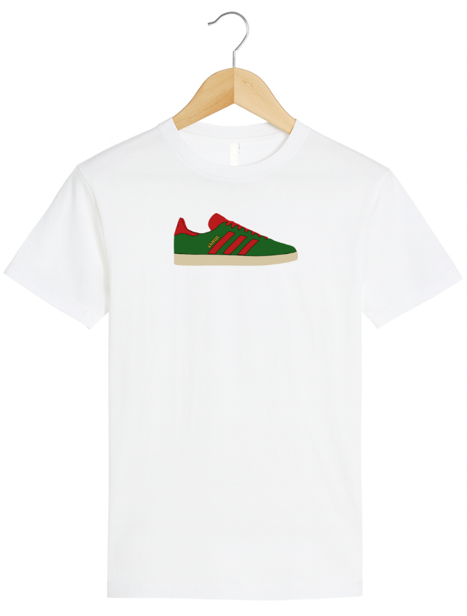 White t-shirt with a green and red sneaker graphic on a hanger against a white background