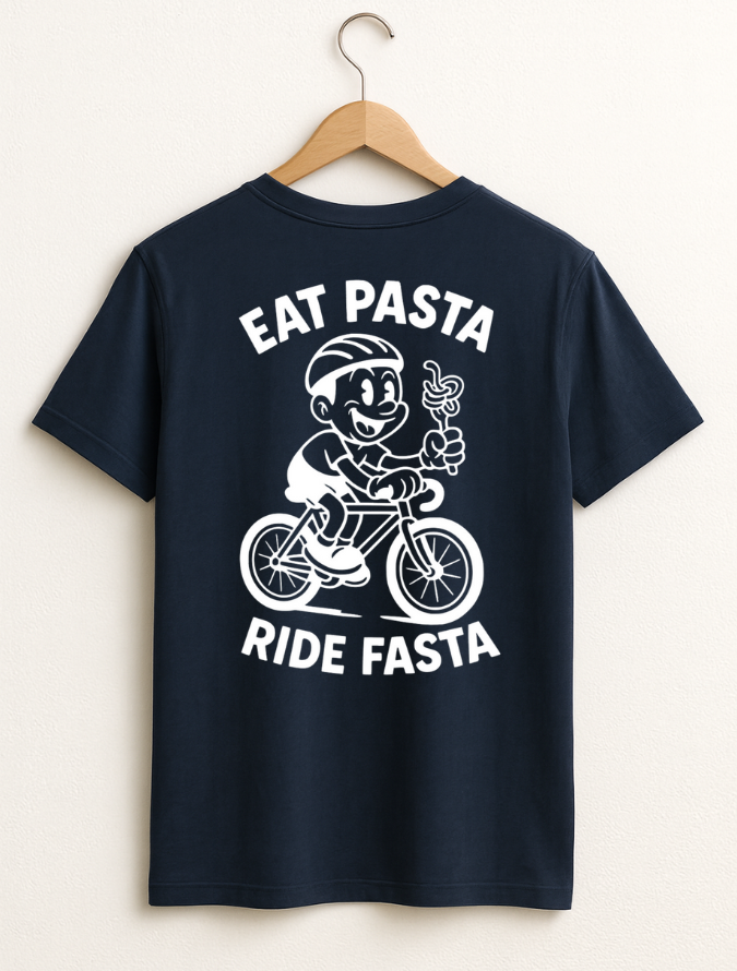 Navy blue t-shirt with a graphic of a character riding a bike and text 'Eat Pasta Ride Fasta' on a hanger.