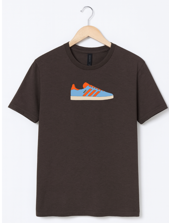 Brown t-shirt with a shoe graphic on a hanger against a white background