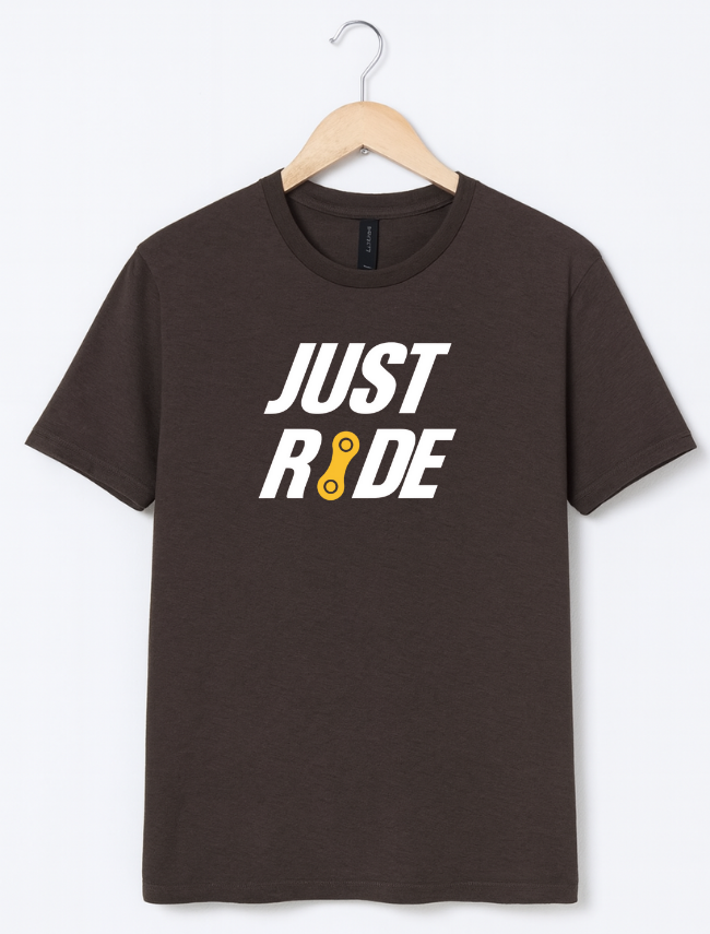 Brown t-shirt with 'JUST RIDE' text on a hanger against a white background