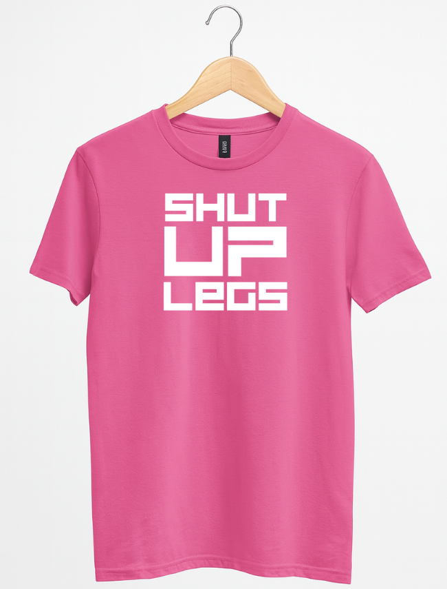 Pink t-shirt with 'SHUT UP LEGS' text on a hanger against a white background
