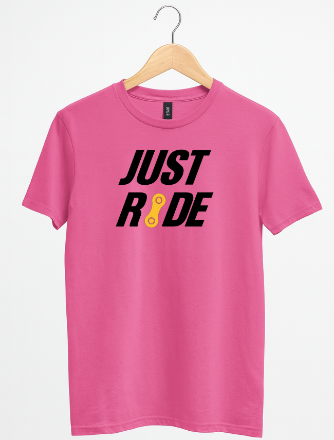 Pink t-shirt with 'JUST RIDE' text on a hanger against a white background