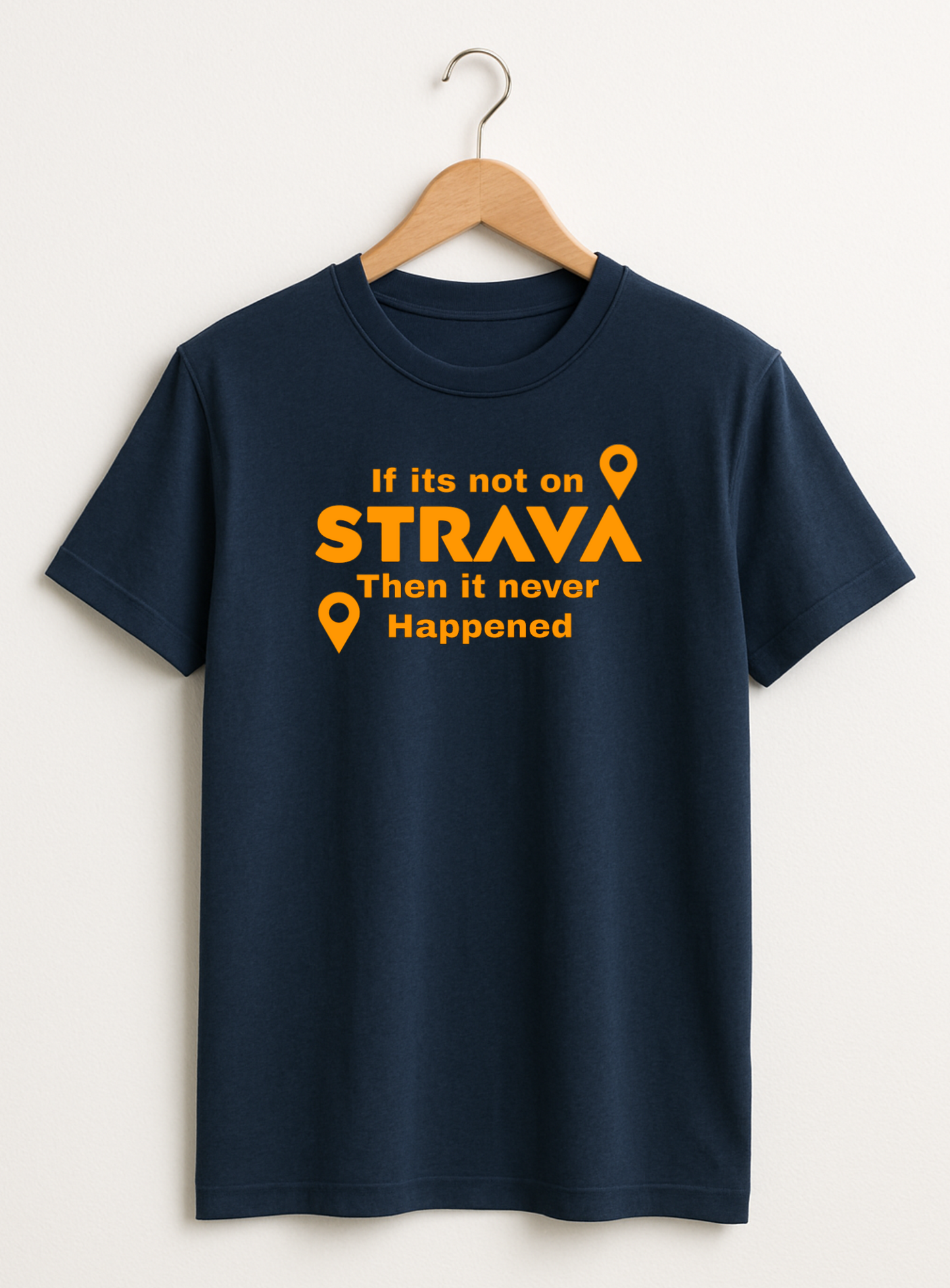 Navy blue t-shirt with orange strava 
text and graphics on a hanger against a white background