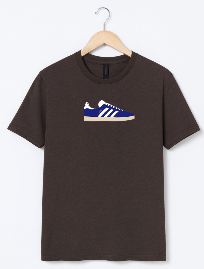 Brown t-shirt with a blue and white sneaker graphic on a hanger against a white background
