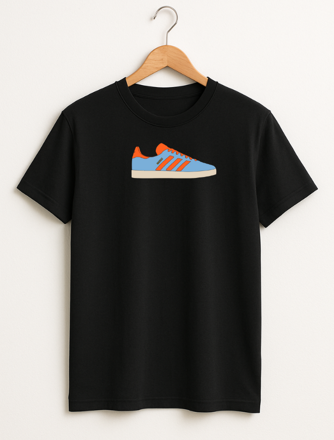 Black t-shirt with a colorful shoe graphic on a hanger against a white background