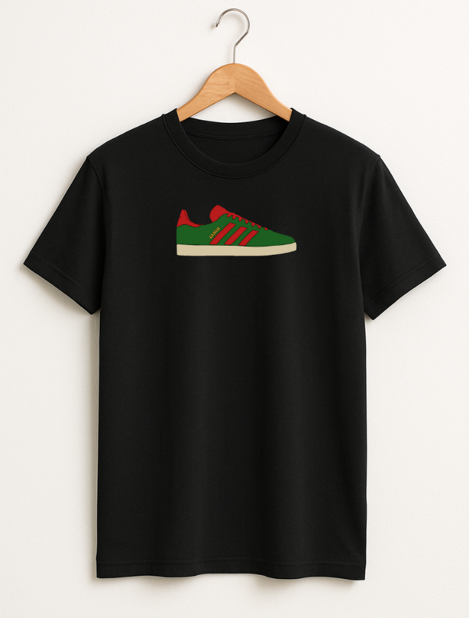 Black t-shirt with a green and red shoe graphic on a hanger against a white background