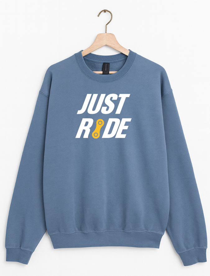 Blue sweatshirt with 'JUST RIDE' text on a hanger against a white background