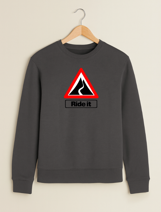 Grey sweatshirt with a red and black traffic sign design and 'Ride it' text on a beige background.