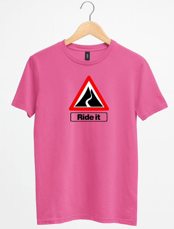 Pink t-shirt with a road sign graphic and 'Ride it' text on a hanger against a white background