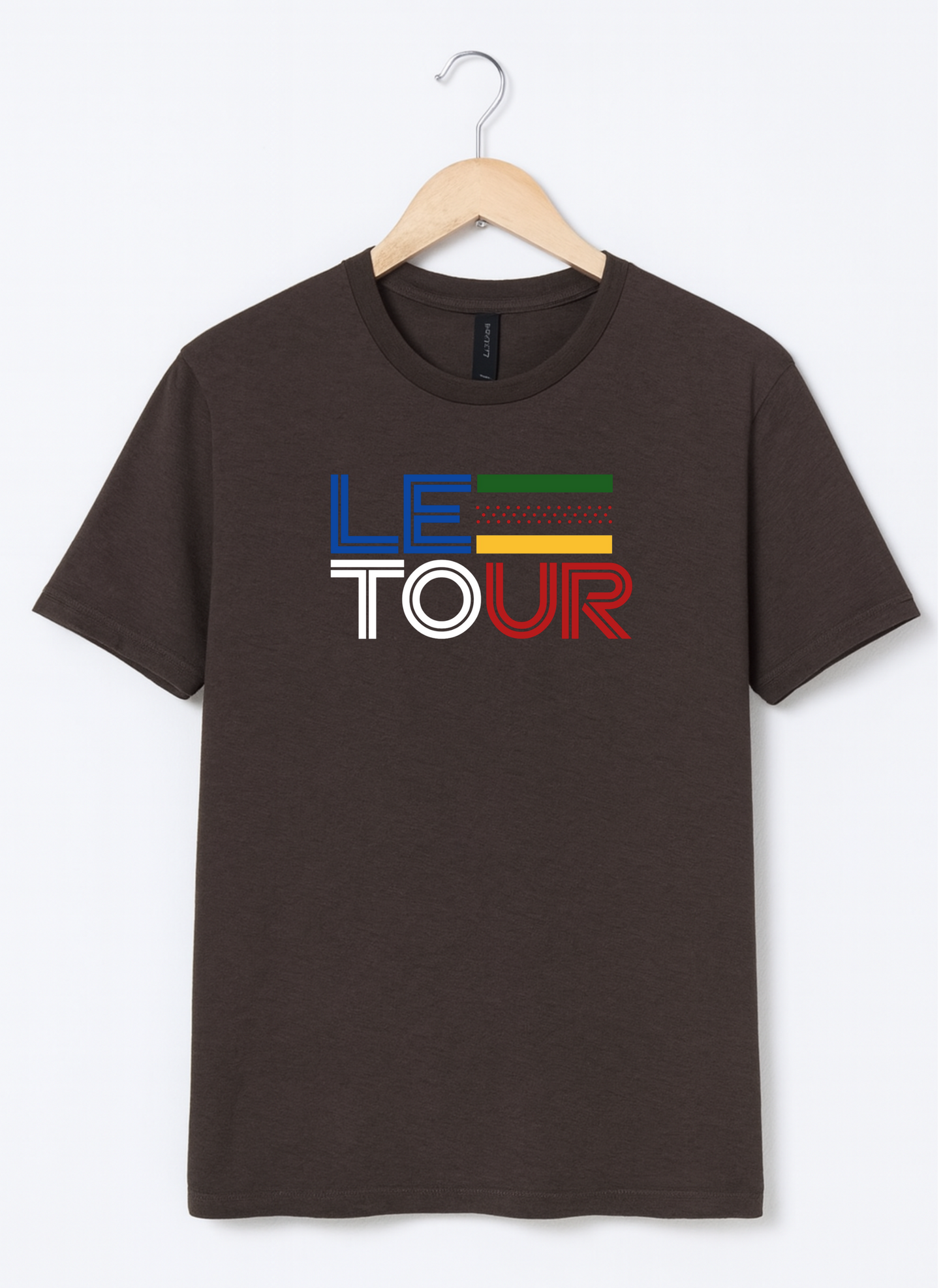 Brown t-shirt with 'Le Tour' text on a hanger against a white background