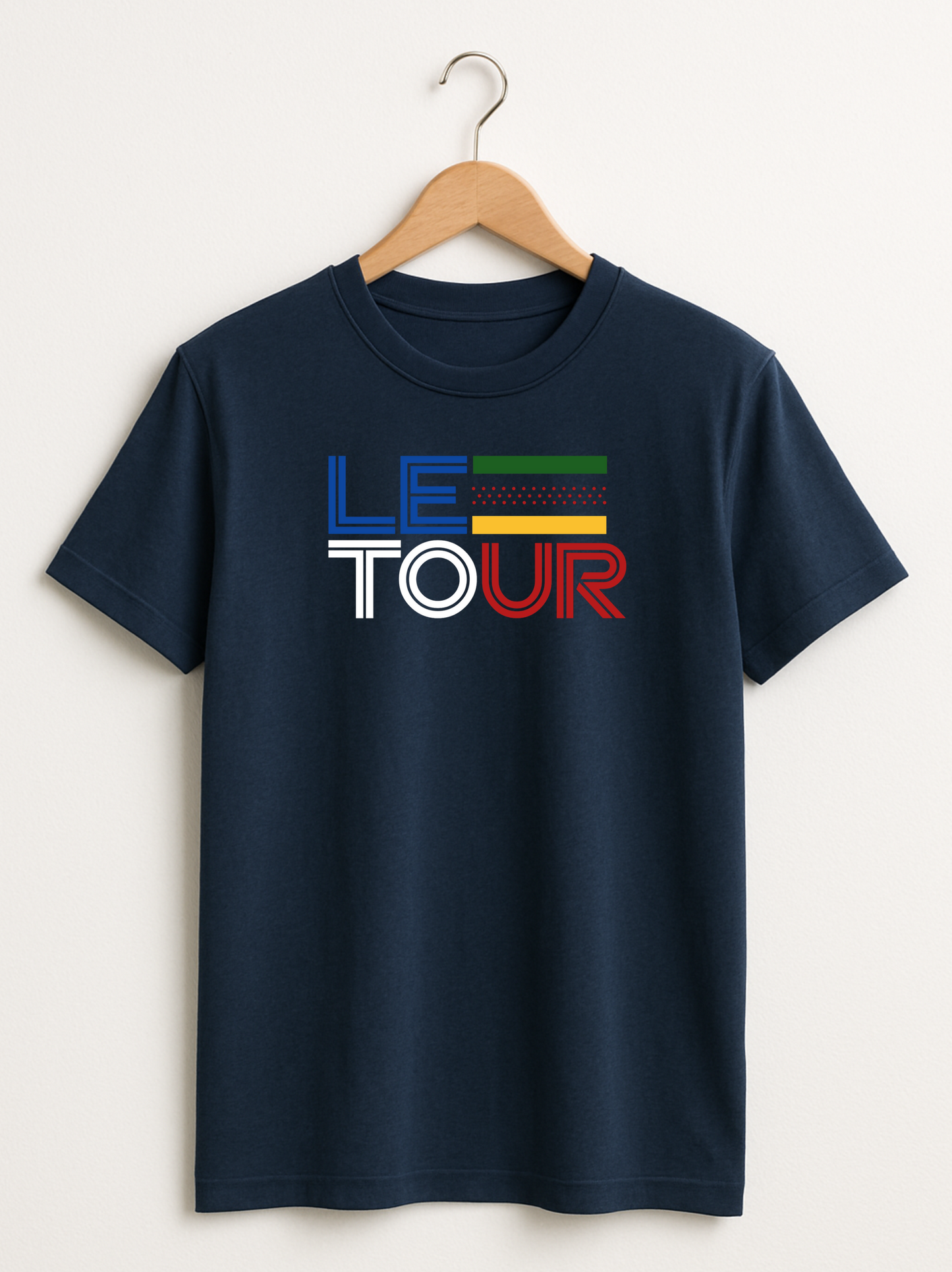 Navy blue t-shirt with 'LE TOUR' text on a hanger against a white background