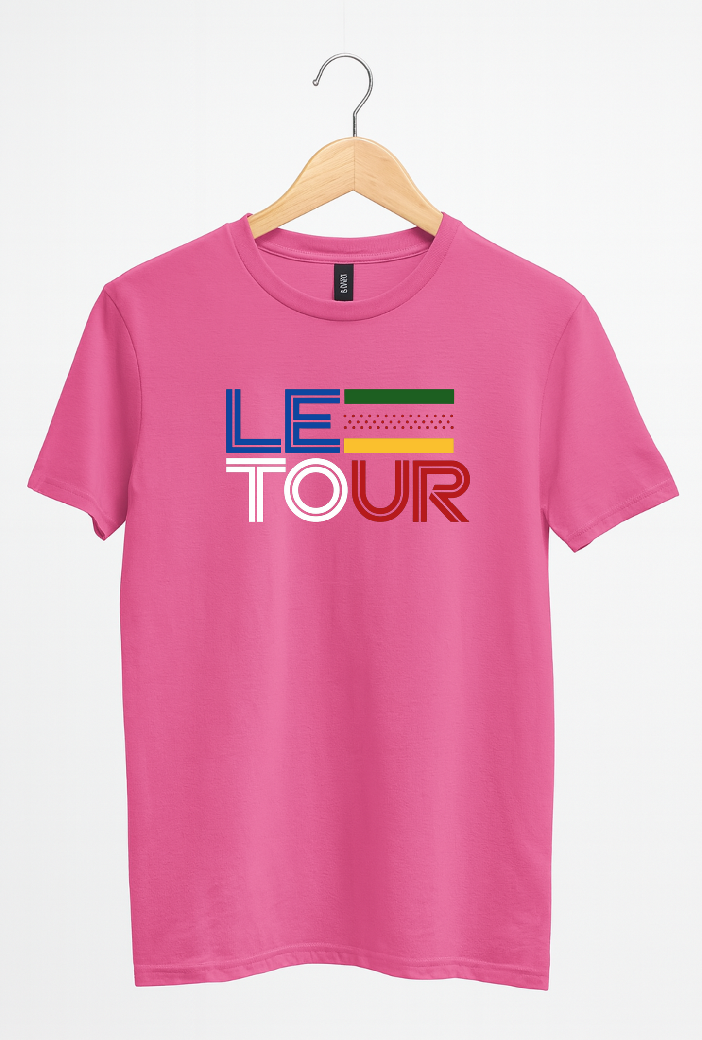 Pink t-shirt with 'Le Tour' text on a hanger against a white background